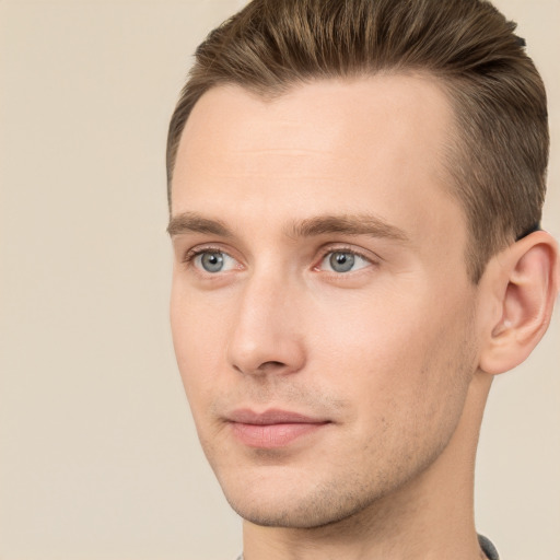 Joyful white young-adult male with short  brown hair and grey eyes