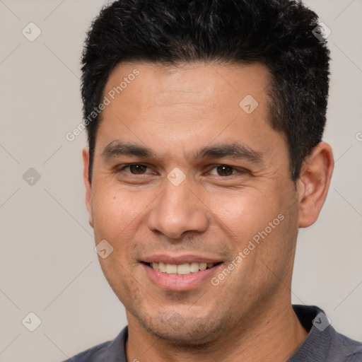 Joyful white adult male with short  black hair and brown eyes