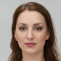 Joyful white young-adult female with long  brown hair and green eyes