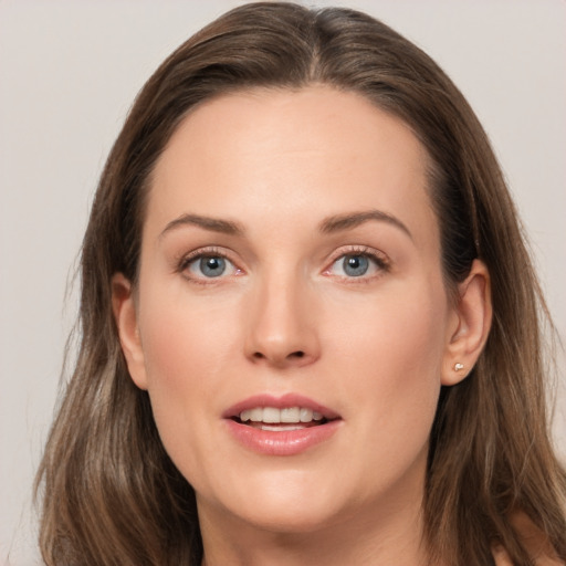 Joyful white young-adult female with long  brown hair and grey eyes