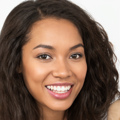 Joyful latino young-adult female with long  brown hair and brown eyes