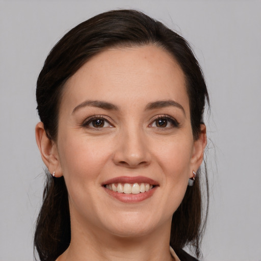 Joyful white young-adult female with medium  brown hair and brown eyes