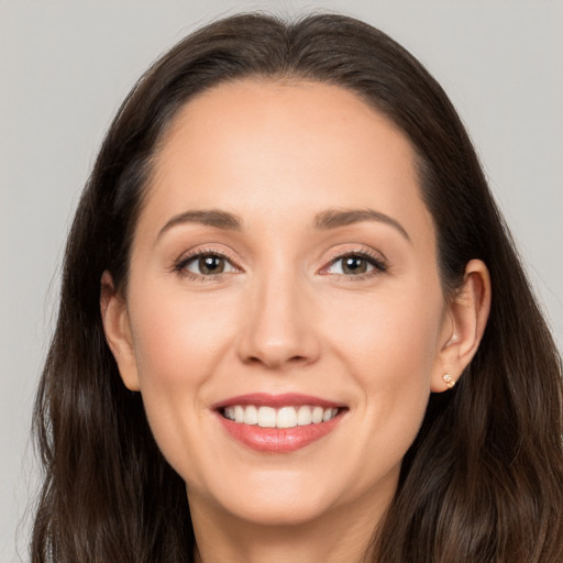 Joyful white young-adult female with long  brown hair and brown eyes