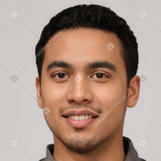 Joyful latino young-adult male with short  black hair and brown eyes