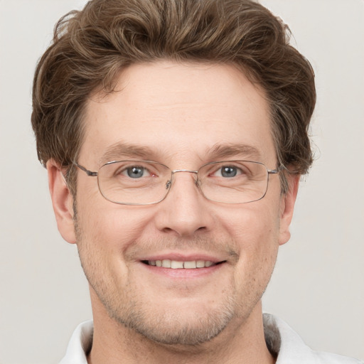 Joyful white adult male with short  brown hair and grey eyes