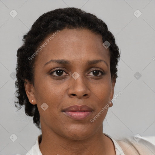 Joyful black adult female with short  brown hair and brown eyes