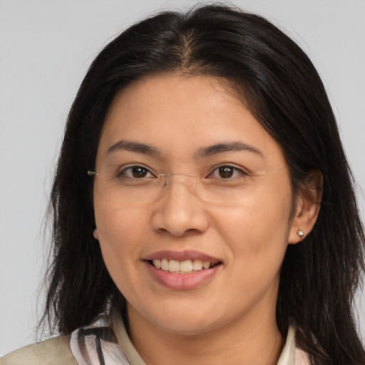 Joyful latino adult female with medium  brown hair and brown eyes