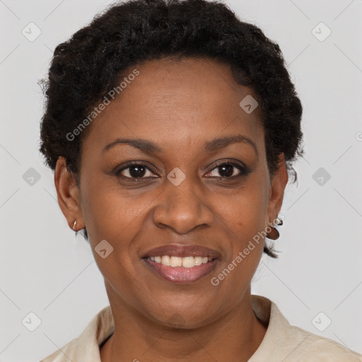 Joyful black adult female with short  brown hair and brown eyes