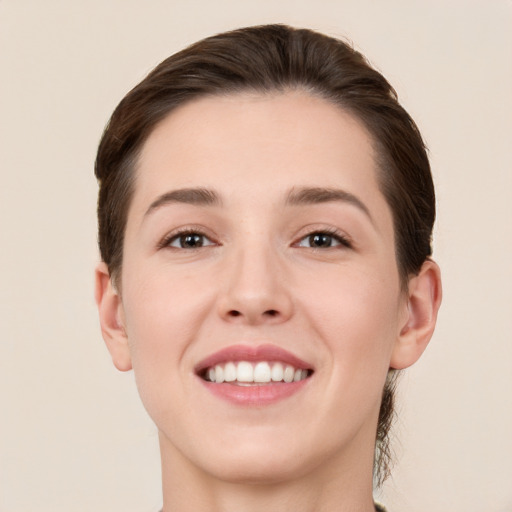 Joyful white young-adult female with short  brown hair and brown eyes