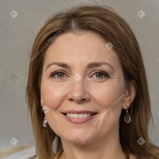 Joyful white adult female with long  brown hair and brown eyes