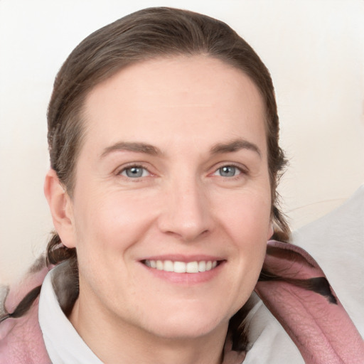 Joyful white young-adult female with medium  brown hair and grey eyes