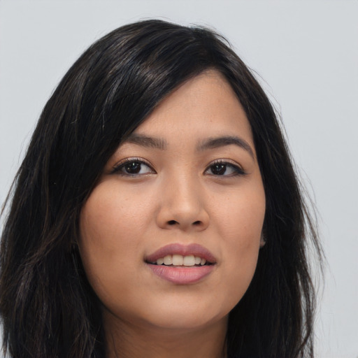Joyful asian young-adult female with long  black hair and brown eyes
