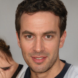 Joyful white adult male with short  brown hair and brown eyes