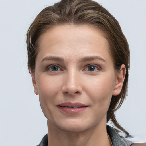 Joyful white young-adult female with medium  brown hair and grey eyes