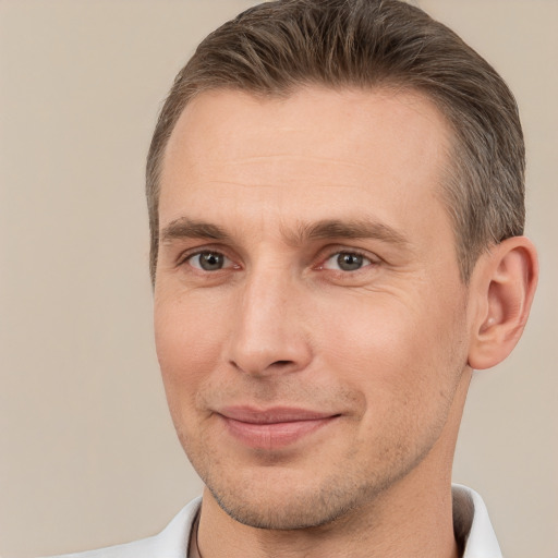 Joyful white adult male with short  brown hair and brown eyes