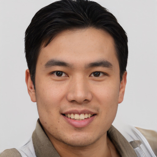 Joyful asian young-adult male with short  brown hair and brown eyes