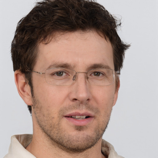 Joyful white adult male with short  brown hair and brown eyes