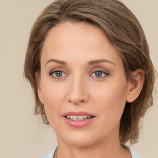 Joyful white young-adult female with medium  brown hair and green eyes