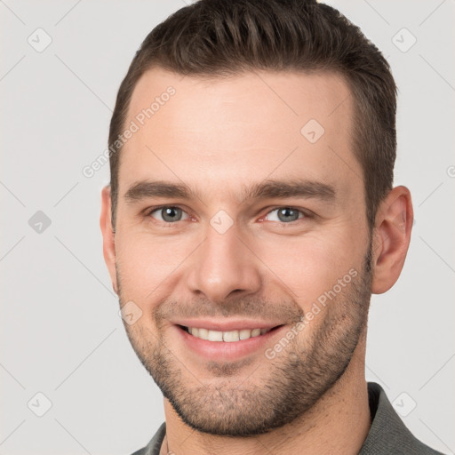 Joyful white young-adult male with short  brown hair and brown eyes