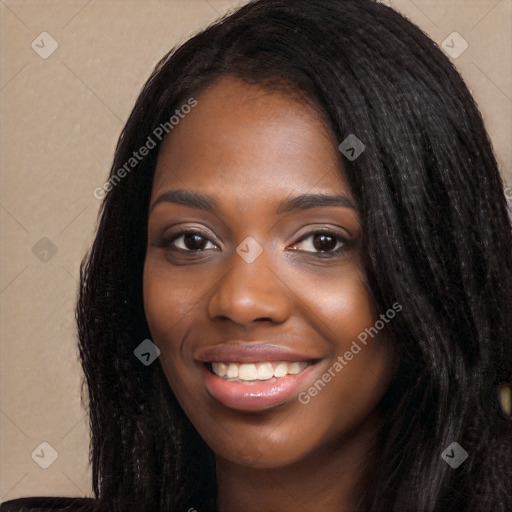 Joyful black young-adult female with long  black hair and brown eyes