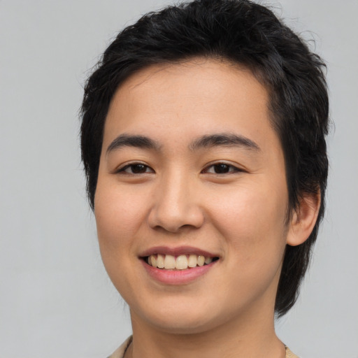 Joyful asian young-adult male with medium  black hair and brown eyes