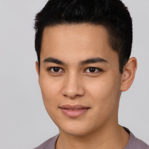 Joyful latino young-adult male with short  brown hair and brown eyes