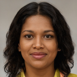 Joyful black young-adult female with medium  brown hair and brown eyes