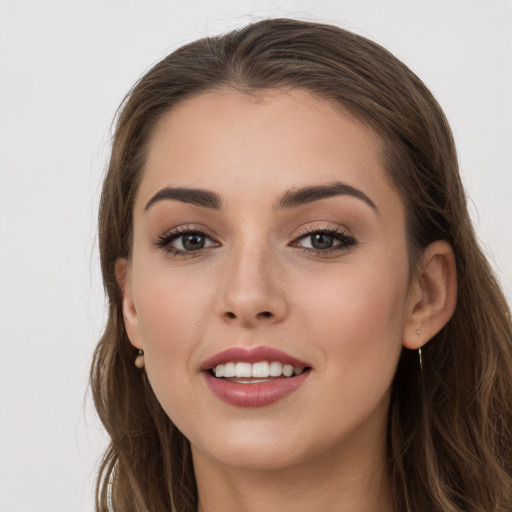 Joyful white young-adult female with long  brown hair and grey eyes