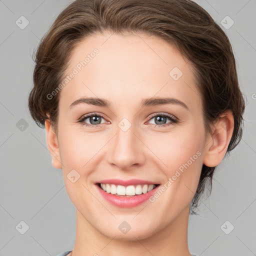 Joyful white young-adult female with medium  brown hair and green eyes