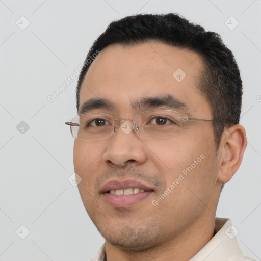 Joyful white young-adult male with short  black hair and brown eyes