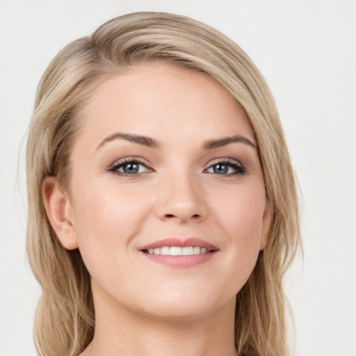 Joyful white young-adult female with long  brown hair and green eyes