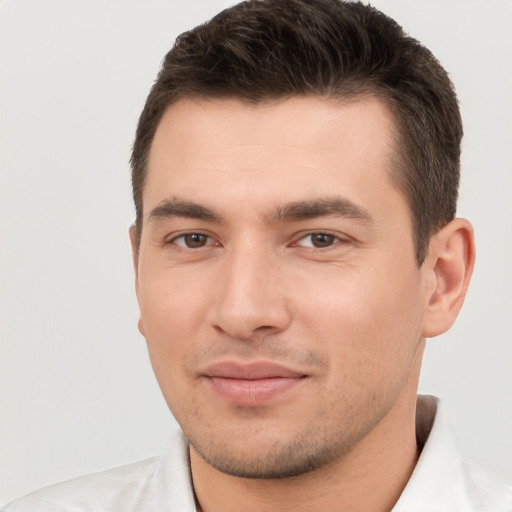 Joyful white young-adult male with short  brown hair and brown eyes