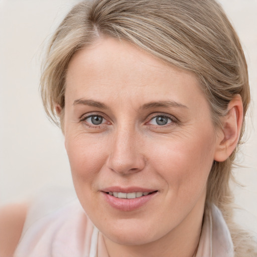 Joyful white young-adult female with medium  brown hair and blue eyes