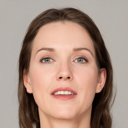 Joyful white young-adult female with medium  brown hair and grey eyes