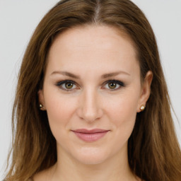 Joyful white young-adult female with long  brown hair and green eyes