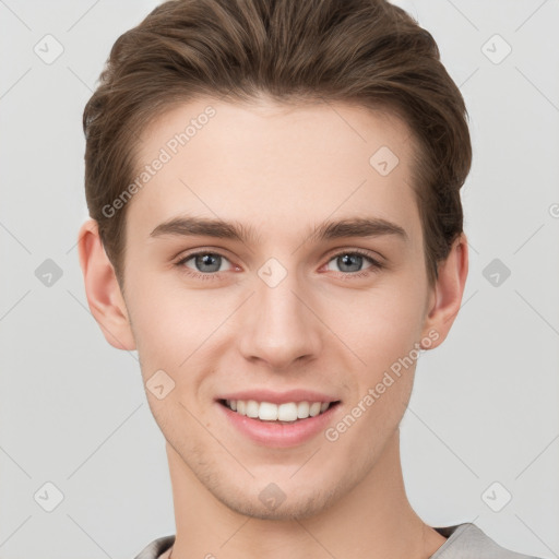 Joyful white young-adult male with short  brown hair and grey eyes