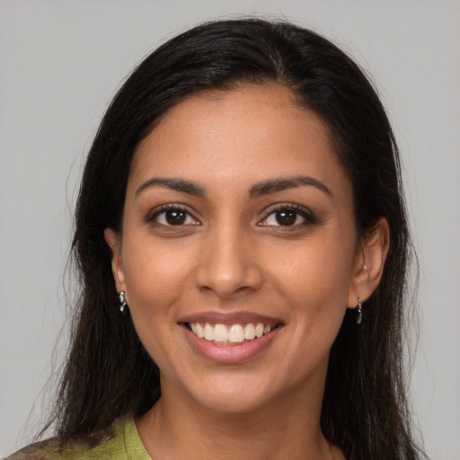 Joyful latino young-adult female with medium  brown hair and brown eyes