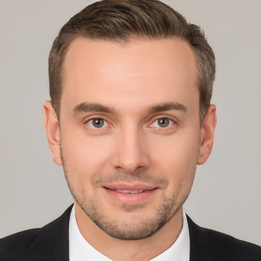 Joyful white young-adult male with short  brown hair and brown eyes