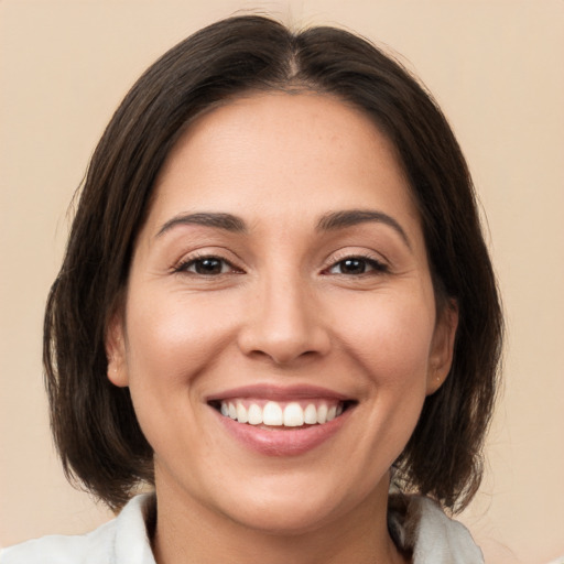 Joyful white young-adult female with medium  brown hair and brown eyes