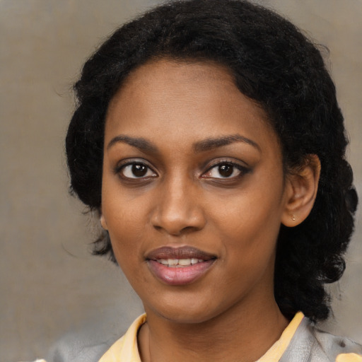 Joyful black young-adult female with medium  black hair and brown eyes