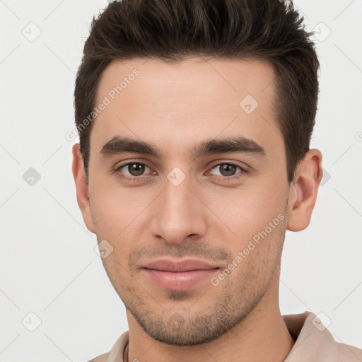 Joyful white young-adult male with short  brown hair and brown eyes