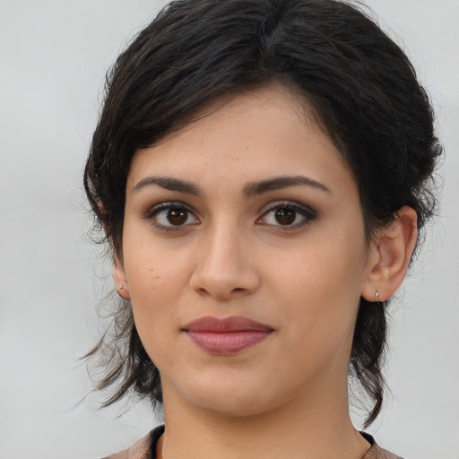 Joyful latino young-adult female with medium  brown hair and brown eyes