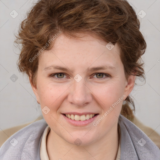 Joyful white young-adult female with medium  brown hair and blue eyes