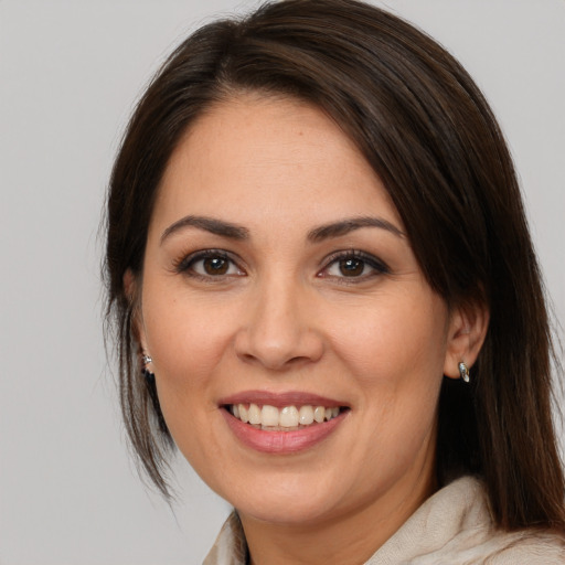 Joyful white young-adult female with medium  brown hair and brown eyes