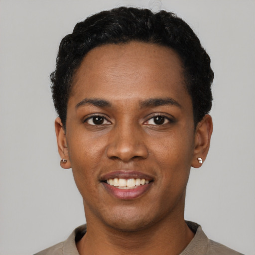 Joyful black young-adult male with short  black hair and brown eyes