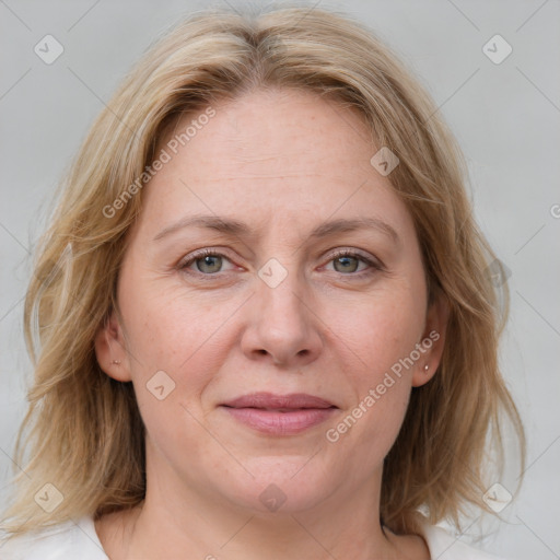 Joyful white adult female with medium  brown hair and blue eyes