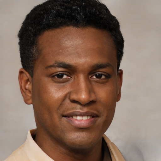 Joyful latino young-adult male with short  brown hair and brown eyes