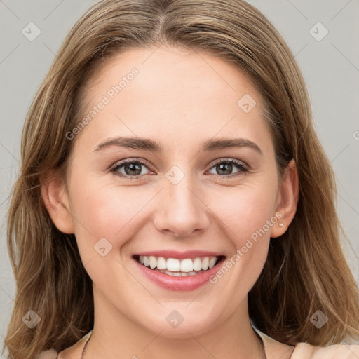 Joyful white young-adult female with long  brown hair and grey eyes