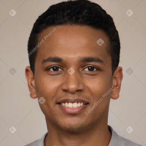 Joyful black young-adult male with short  black hair and brown eyes