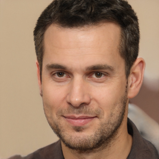 Joyful white adult male with short  brown hair and brown eyes